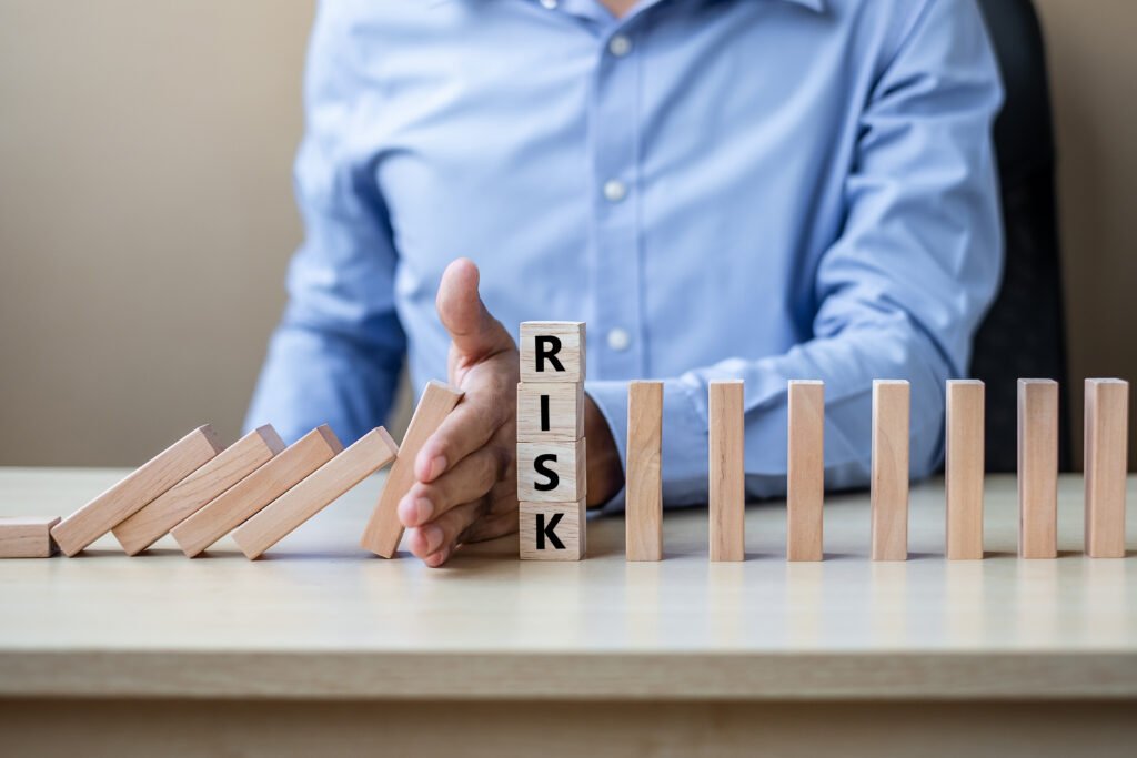 Businessman hand Stopping Falling wooden Blocks or Dominoes. Bus