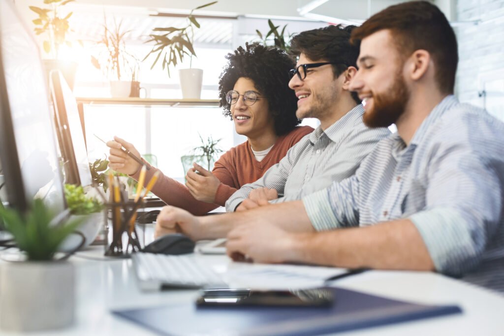 Programmers cooperating at IT company developing apps