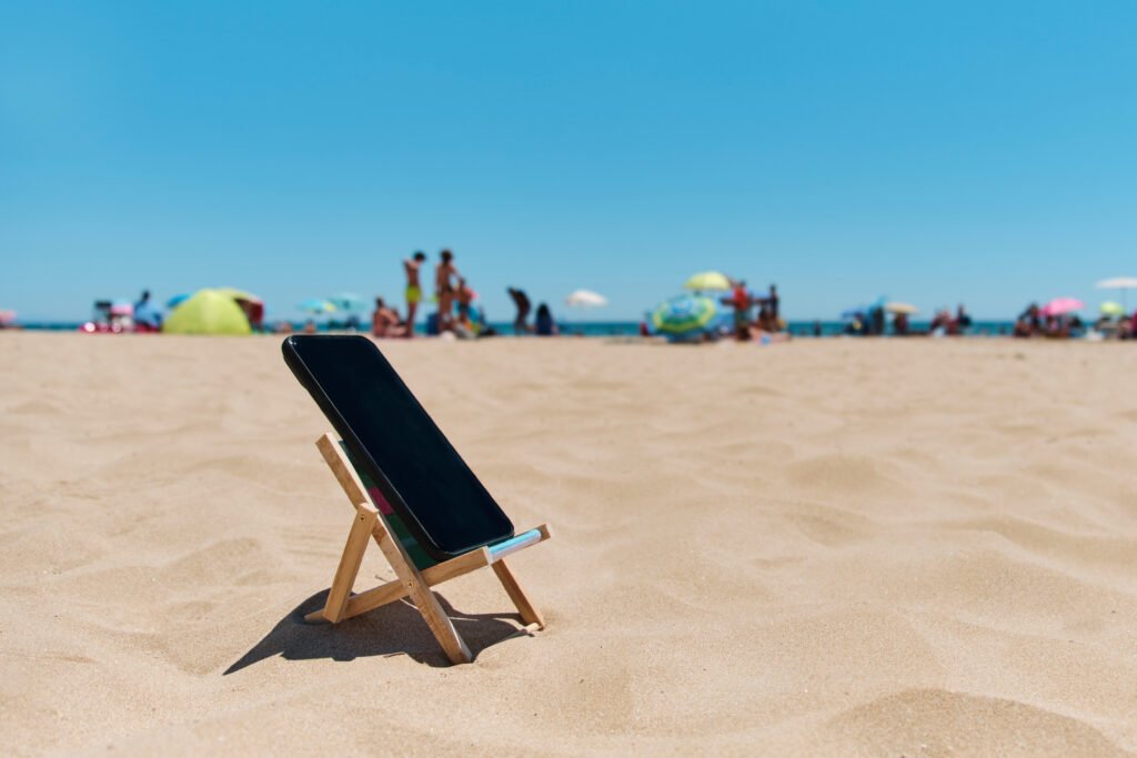 smartphone in a deck chair on the beach
