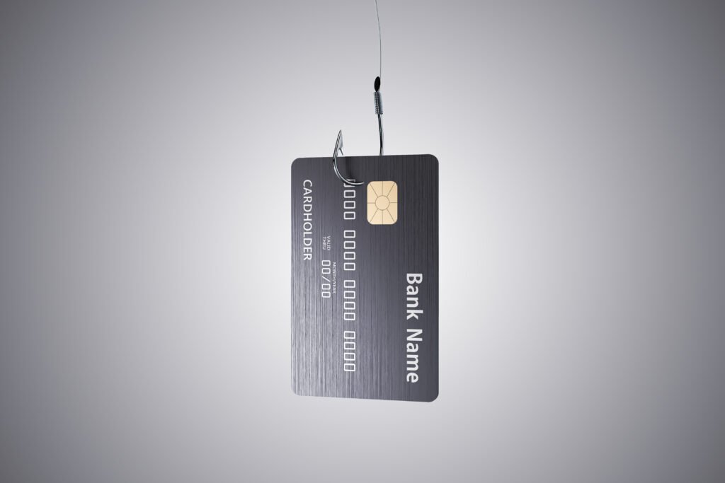 Credit card hanging on a hook on gray backgriund.