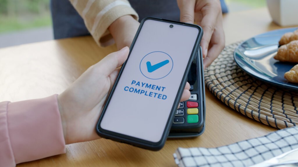 Asia young smile happy woman people in small sme coffee shop store use tapping cashless wifi qr code nfc scan app smart pos device reader sale in food drink order in cafe urban city life contactless.