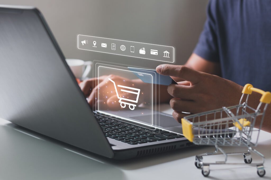 Young man hands holding credit card and using laptop with shopping cart icon. Online shopping, Online payment and e-commerce concept. Business financial technology. hand typing on keyboard.
